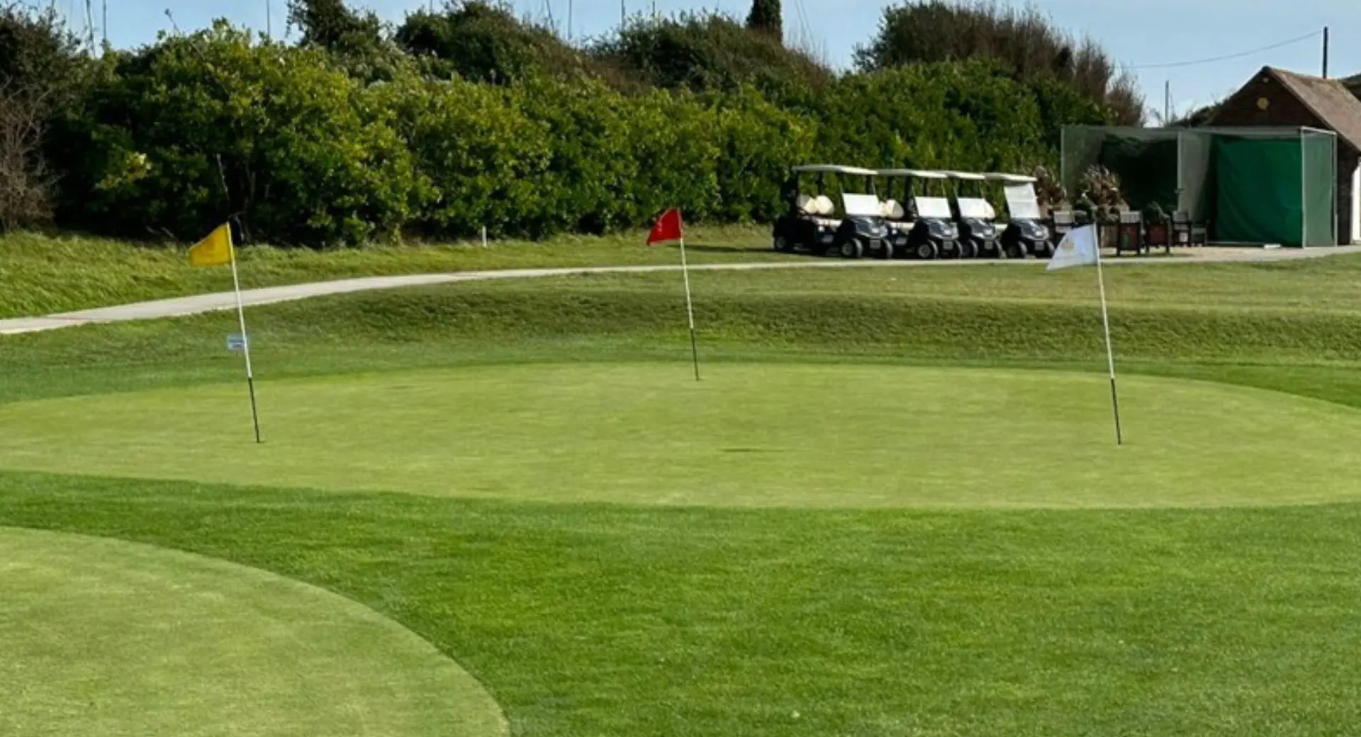 Three golf flags on the green
