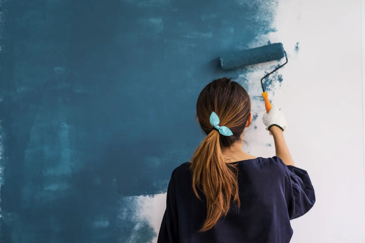 women painting a wall