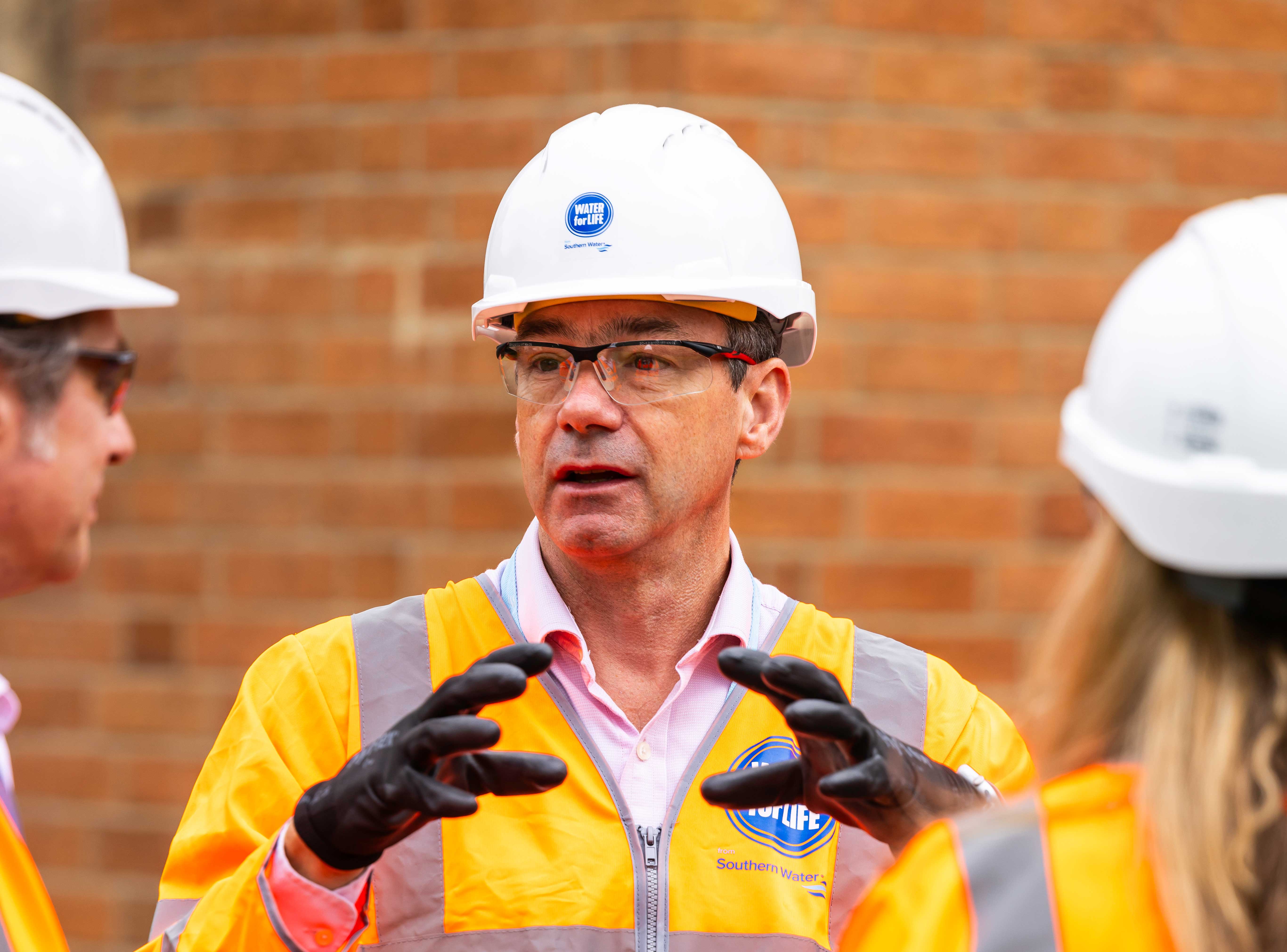Lawrence Gosden on site with workers 
                        