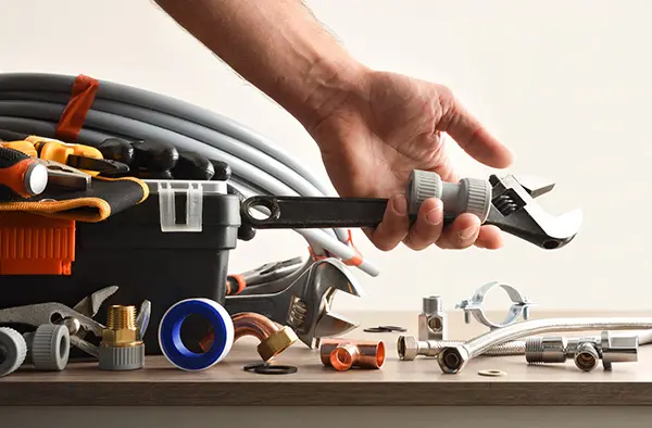 A plumber looking at tools