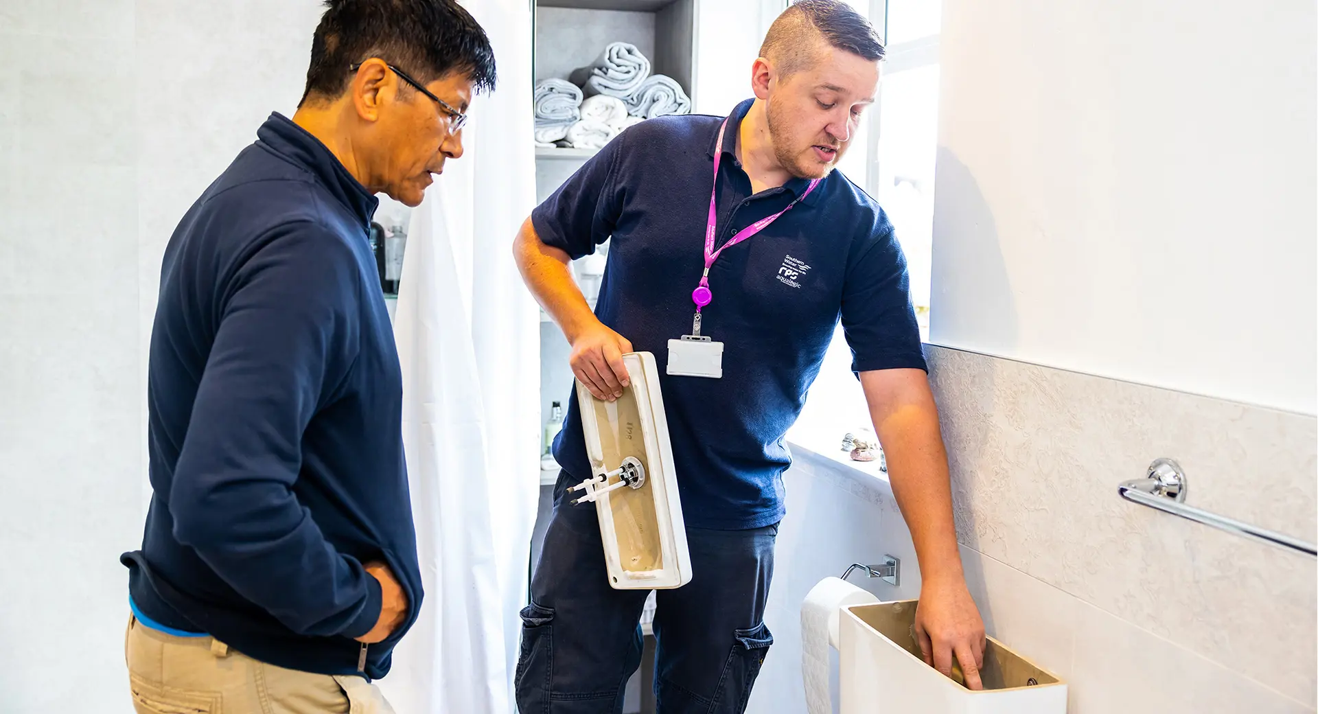Worker show a customer a toilet basin