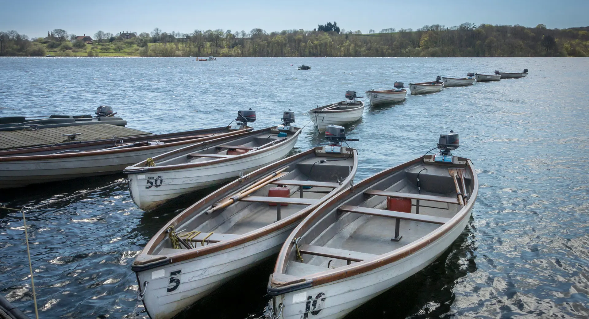 Rowing boats lined up on Bewl Water Reservoir