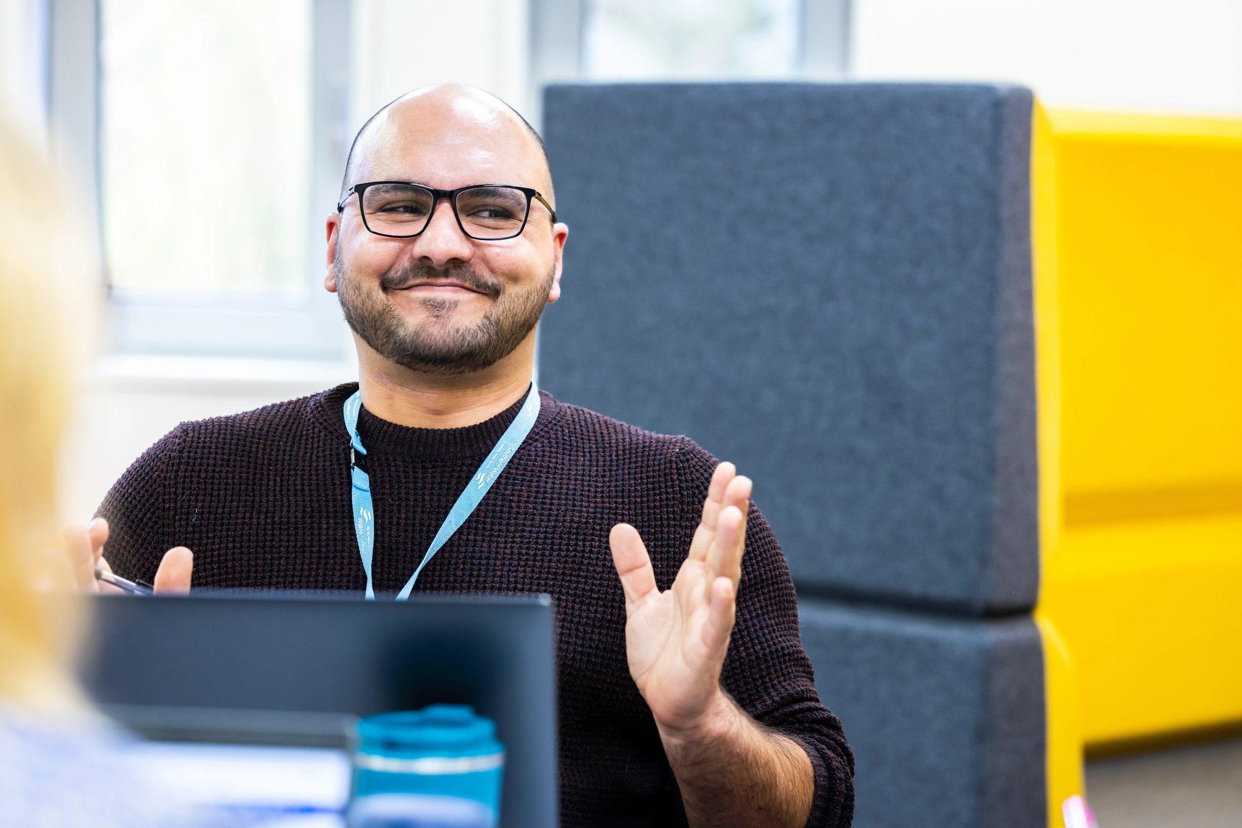Man in the work place looking happy
                        
