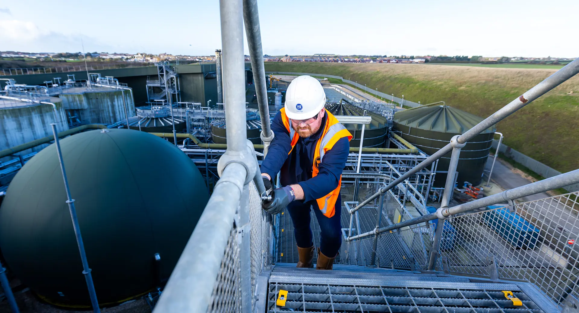 A Southern Water engineer works outdoors at the Peacehaven Wastewater Treatment Works
