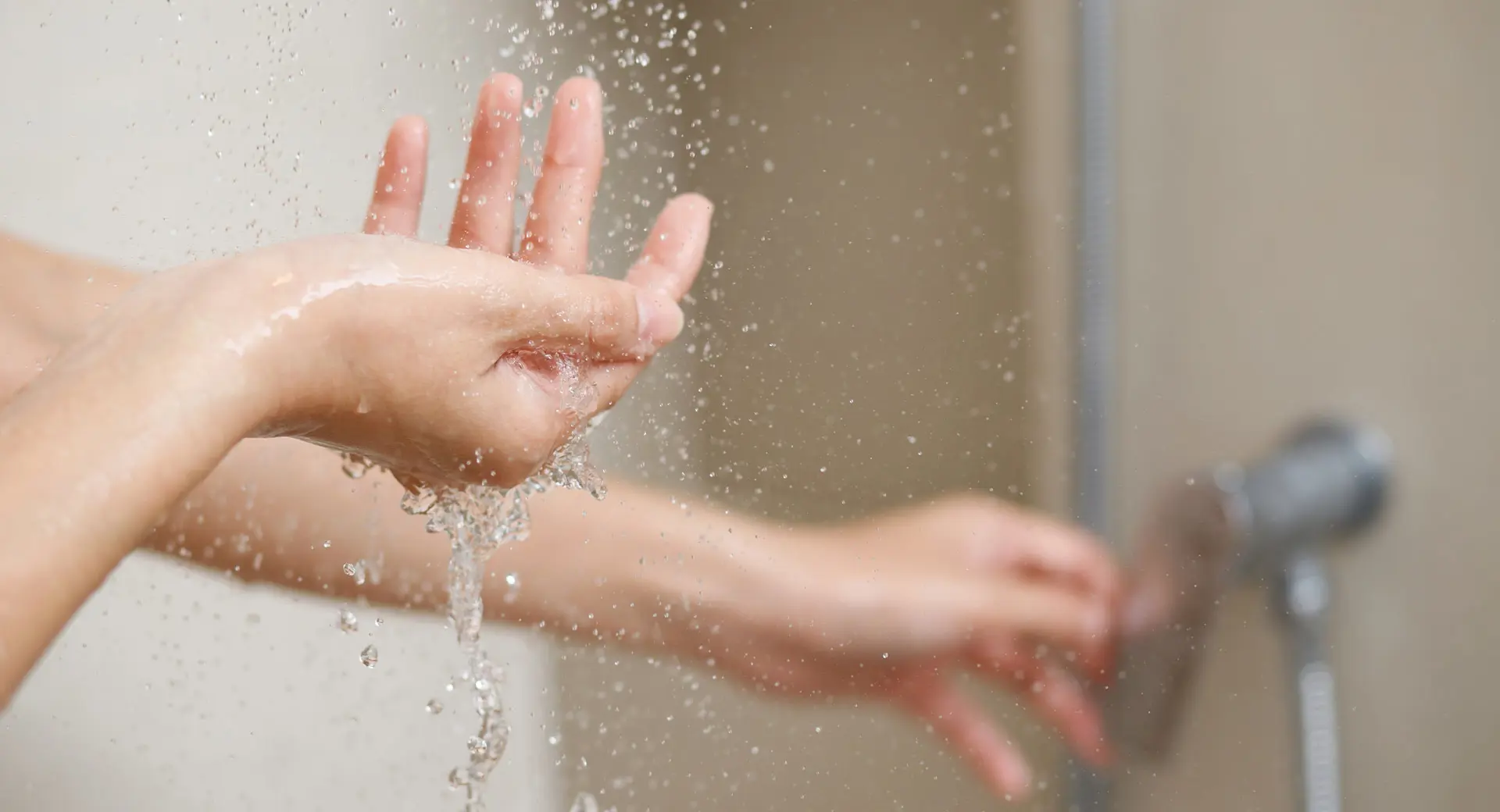 A person washing their hands with water